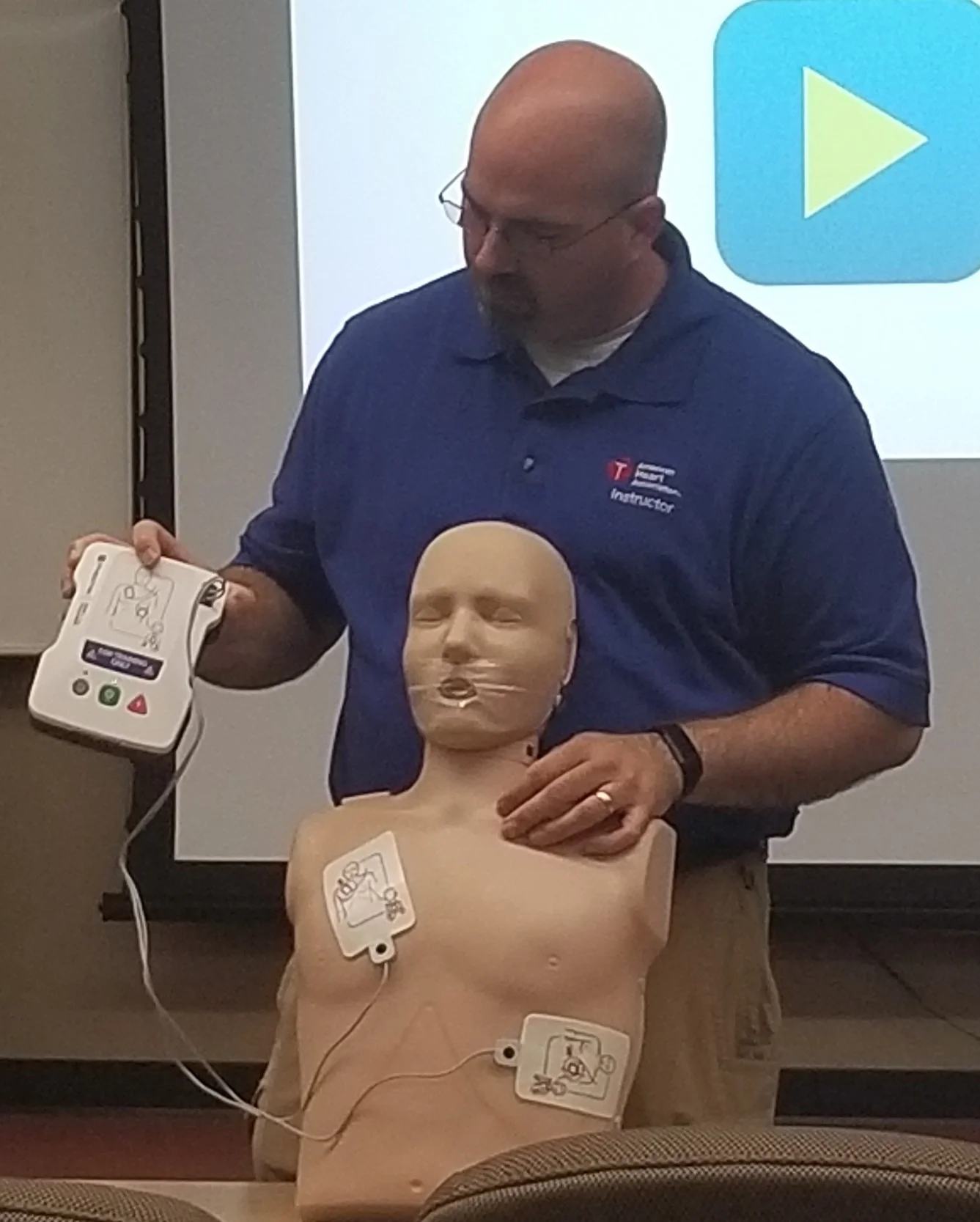 Tim demonstrating AED use during training
